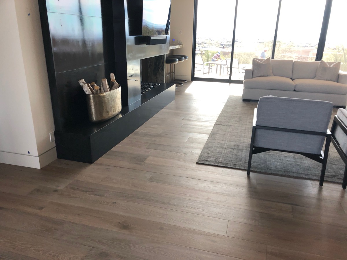 Wide plank oak in a modern living room with fireplace