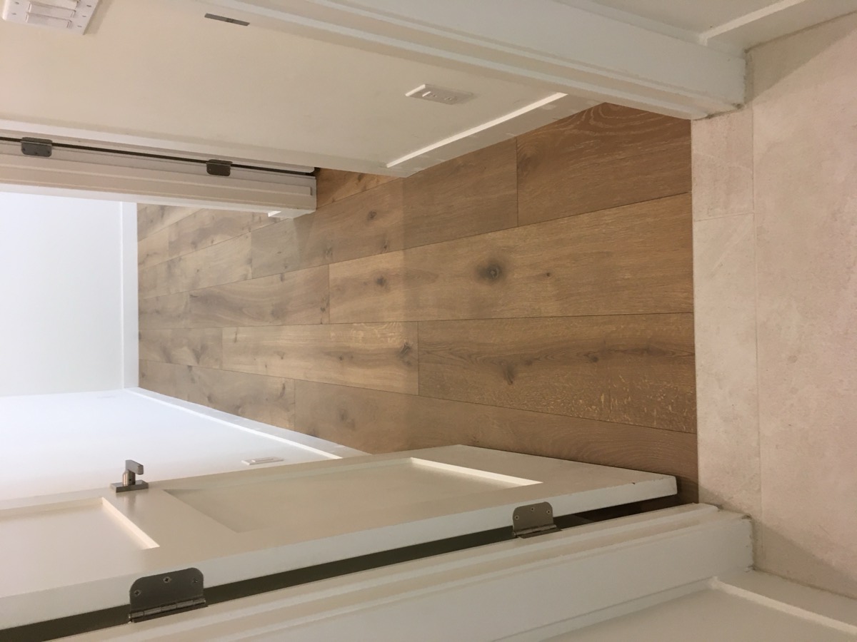 White oak flooring with clean transition to stone tile