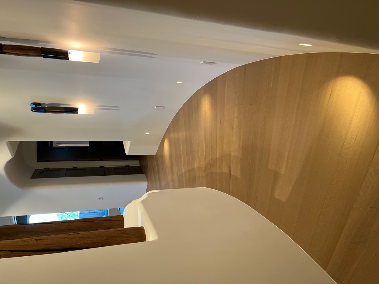 Curved hallway with white oak flooring installed by Olympic Hardwood
